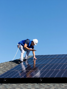 Solar technician checking solar panels on rooftop